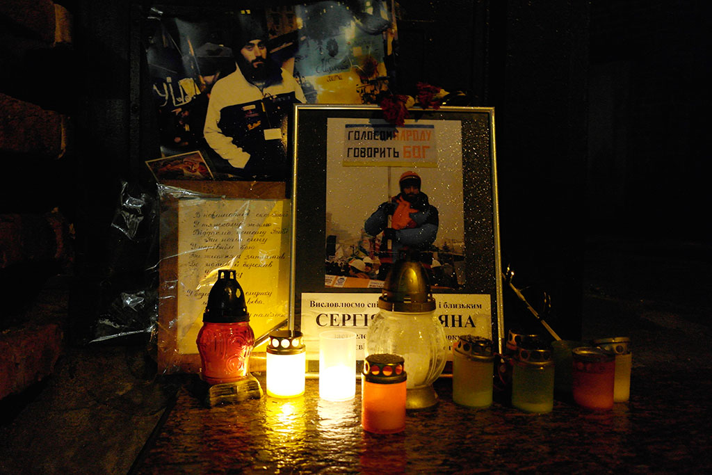 Images and candles at the entrance of the Armenian church commemorate a young man of Armenian origion who was recently killed by the riot police in Kyiv.