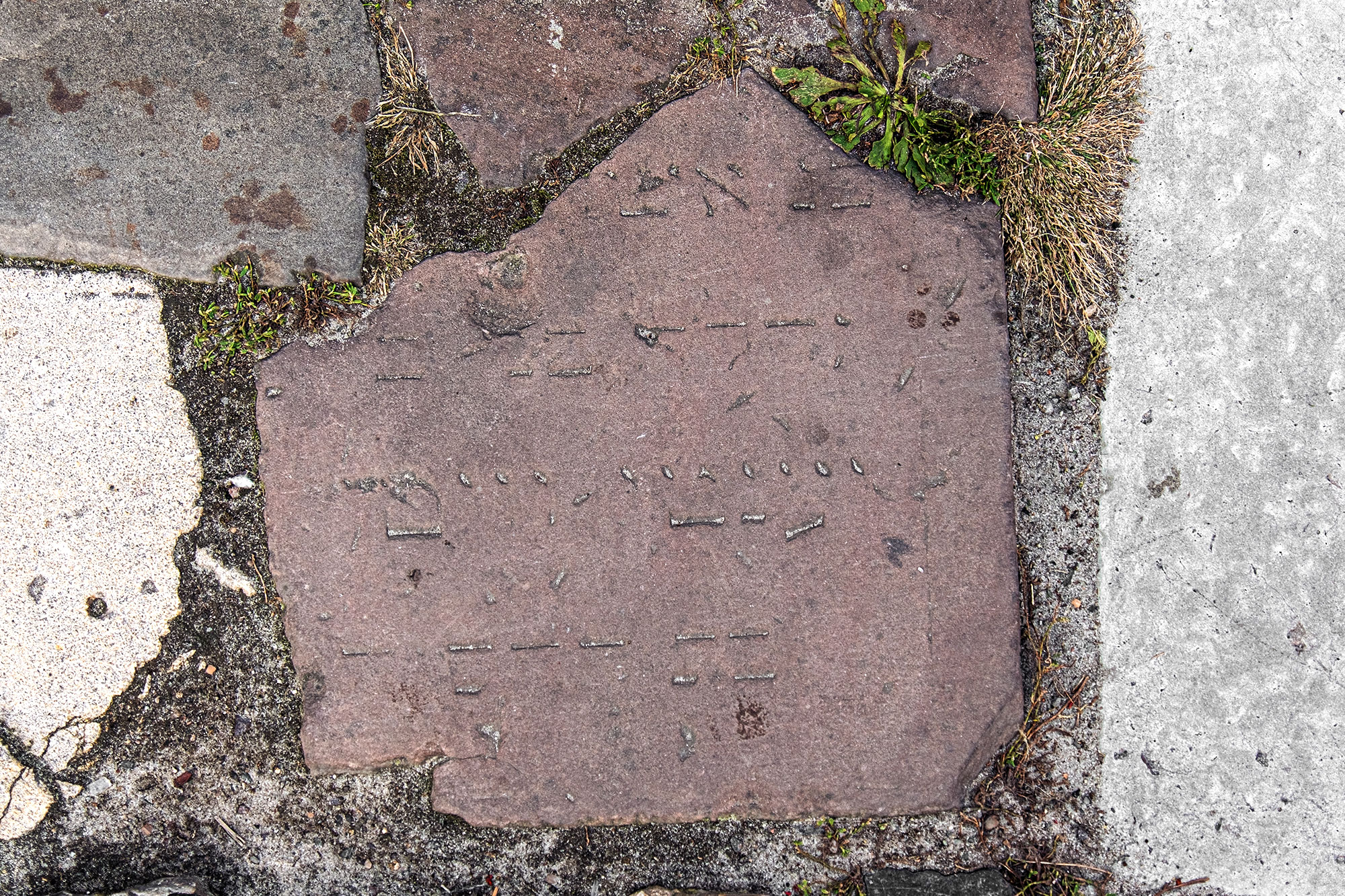 Lviv - fragment of a Jewish tombstone in the street paving